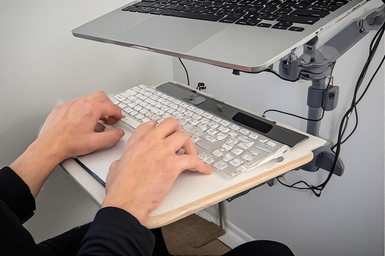 Laptop desk setup with under-desk keyboard tray