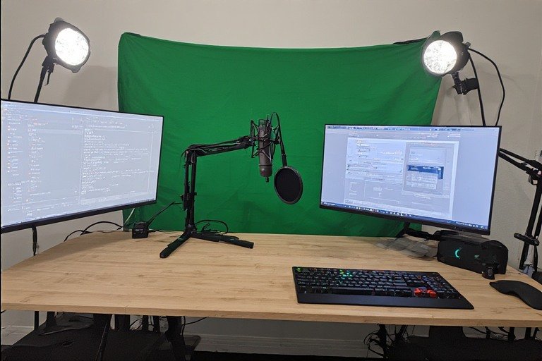 Streaming gaming setup with green screen, microphone, and camera positioning